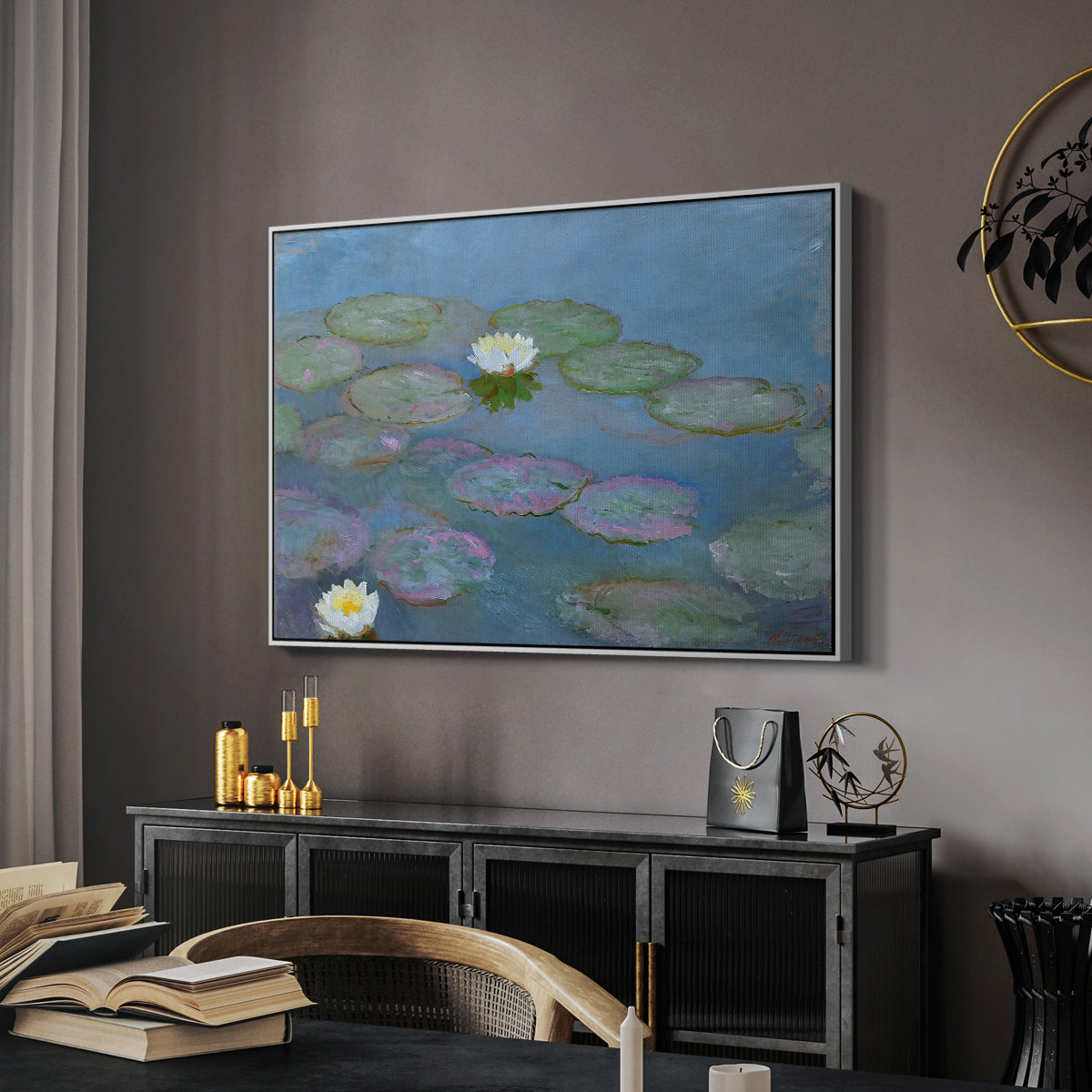 Water Lilies (Nymphéas), 1897-1899 by Claude Monet in a white floater framed canvas featuring a tranquil water surface covered with blooming lilies, displayed above a desk in a dark home office interior.