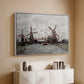 White floater framed canvas of Windmills near Zaandam, 1871 by Claude Monet, featuring an impressionist view of Dutch windmills along riverbank above a console cabinet in a minimalist entryway.