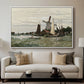 Windmill at Zaandam, 1871 by Claude Monet displayed in a white floater framed canvas above a sofa in a clean living room.
