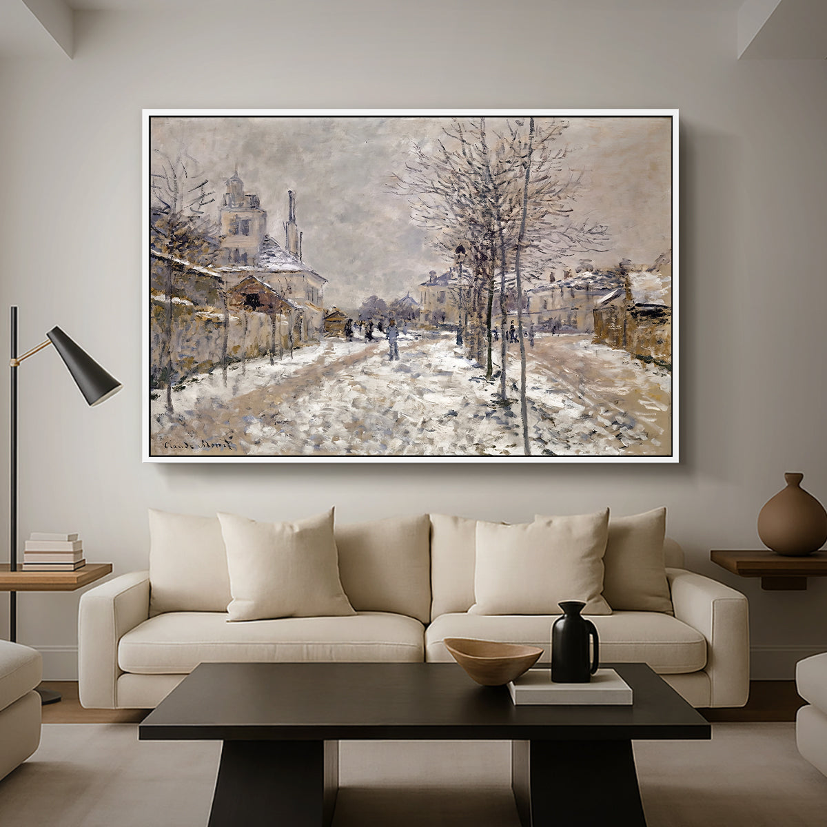 The Boulevard de Pontoise at Argenteuil, Snow Effect, 1875 by Claude Monet as a white floater framed canvas featuring a snow-covered street lined with trees and buildings under winter sky, displayed above a sofa in a modern living room.