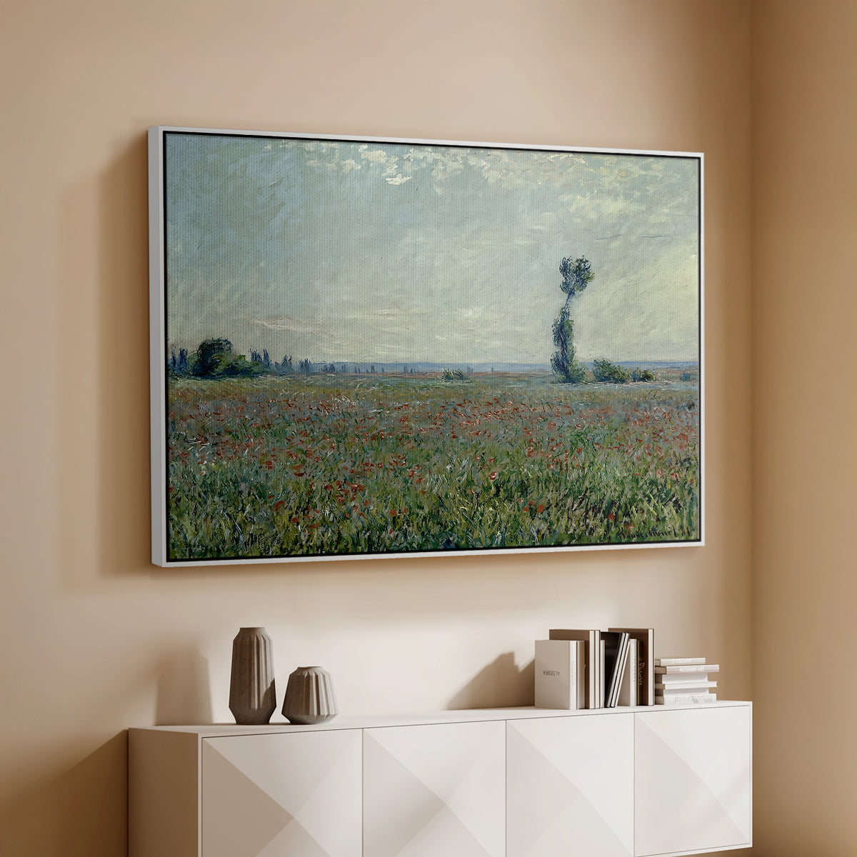 White floater framed canvas of Poppy Field, 1881 by Claude Monet, featuring an impressionist landscape filled with blooming flowers and greenery above a console cabinet in a minimalist entryway.