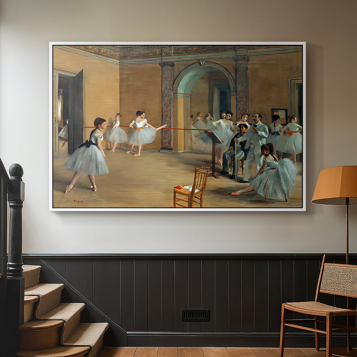 White floater framed canvas featuring an elegant rehearsal space with dancers in soft lighting, displayed in a hallway near a staircase.