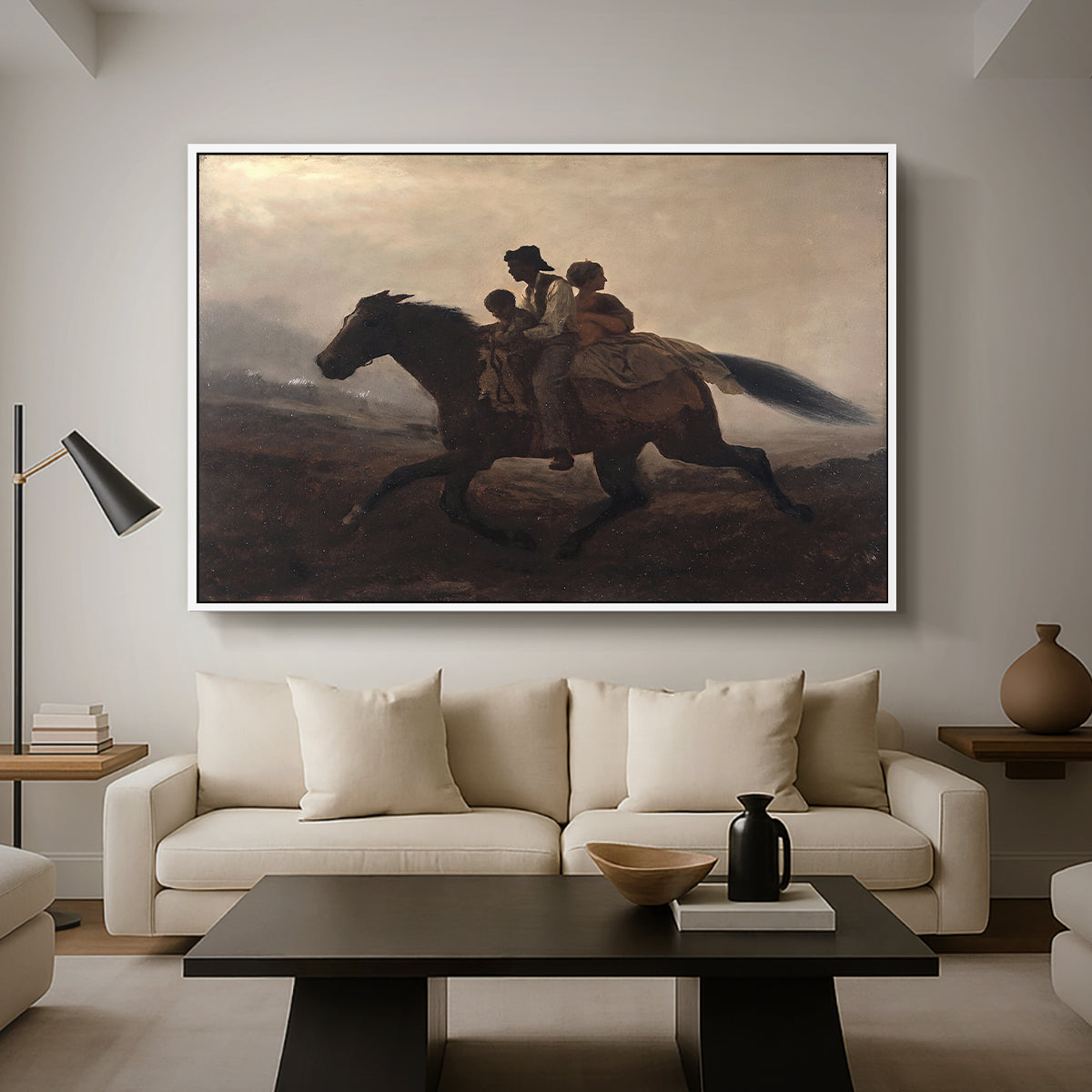 A Ride for Liberty – The Fugitive Slaves, c. 1862 by Eastman Johnson as a white floater framed canvas featuring a family riding horseback through night escaping across landscape, displayed above a sofa in a modern living room.