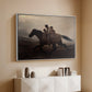 White floater framed canvas of A Ride for Liberty – The Fugitive Slaves, c. 1862 by Eastman Johnson, featuring a dramatic scene of enslaved people fleeing on horseback in darkness above a console cabinet in a minimalist entryway.