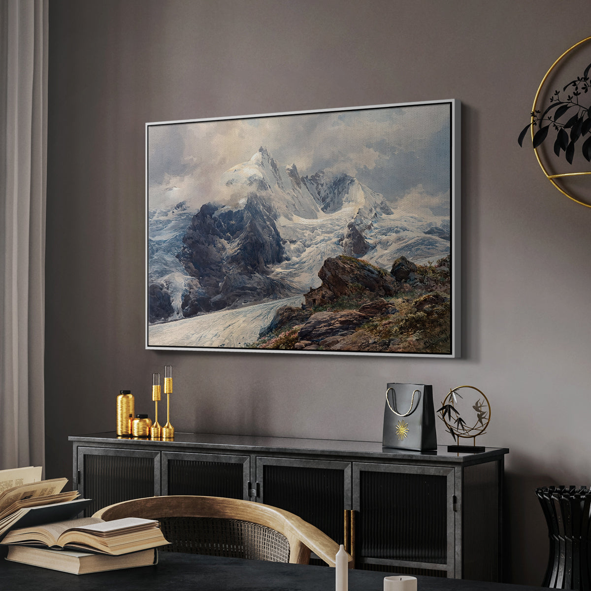 The Grossglockner, 1880 by Edward Theodore Compton in a white floater framed canvas featuring a realistic landscape of high mountain under open sky, displayed above a desk in a dark home office interior.