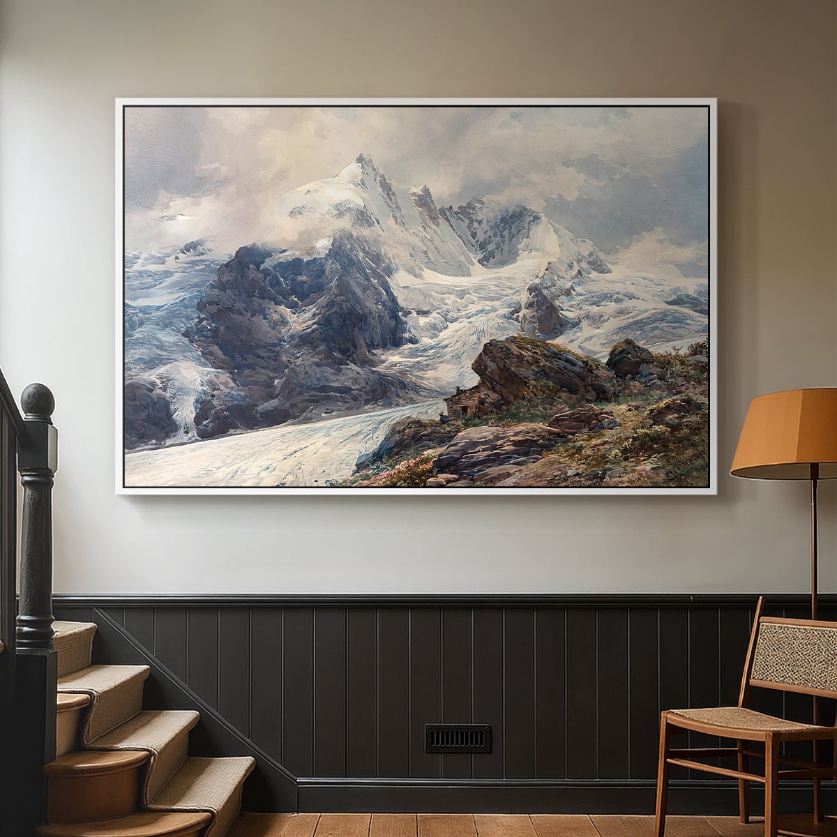 White floater framed canvas featuring an alpine peak dominating surrounding terrain, displayed in a hallway near a staircase.
