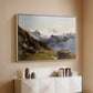 White floater framed canvas of The Großglockner from the Prager Hut, 1890 by Edward Theodore Compton, featuring a mountain summit seen from elevated viewpoint with surrounding landscape above a console cabinet in a minimalist entryway.