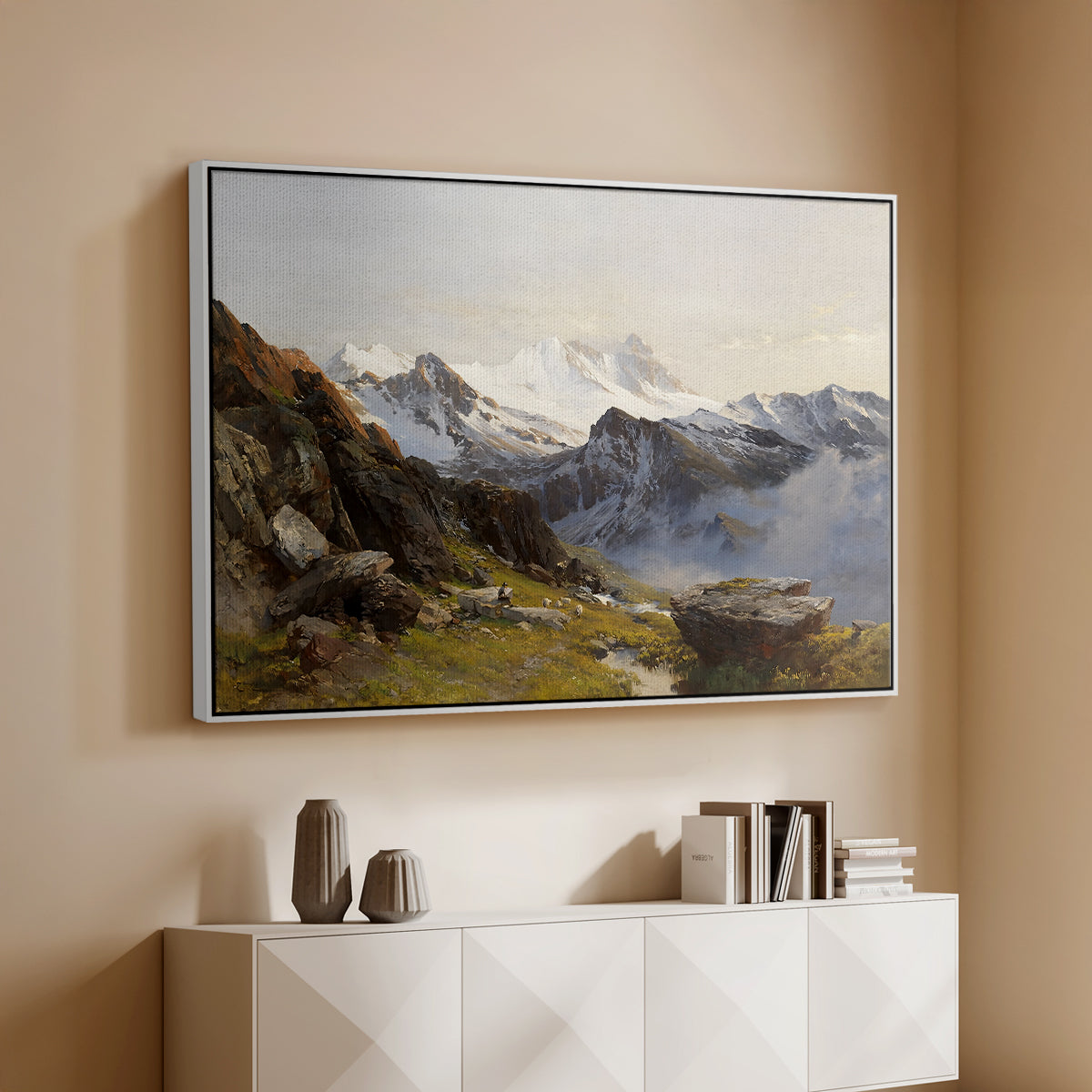White floater framed canvas of The Großglockner from the Prager Hut, 1890 by Edward Theodore Compton, featuring a mountain summit seen from elevated viewpoint with surrounding landscape above a console cabinet in a minimalist entryway.