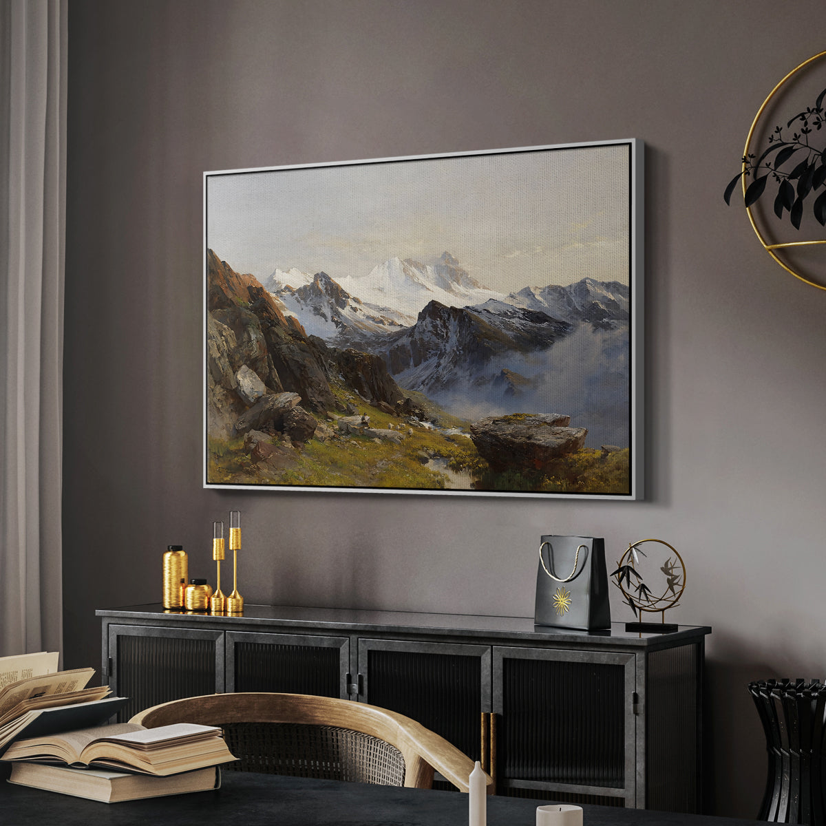 The Großglockner from the Prager Hut, 1890 by Edward Theodore Compton in a white floater framed canvas featuring an alpine vista with towering peak and foreground terrain, displayed above a desk in a dark home office interior.