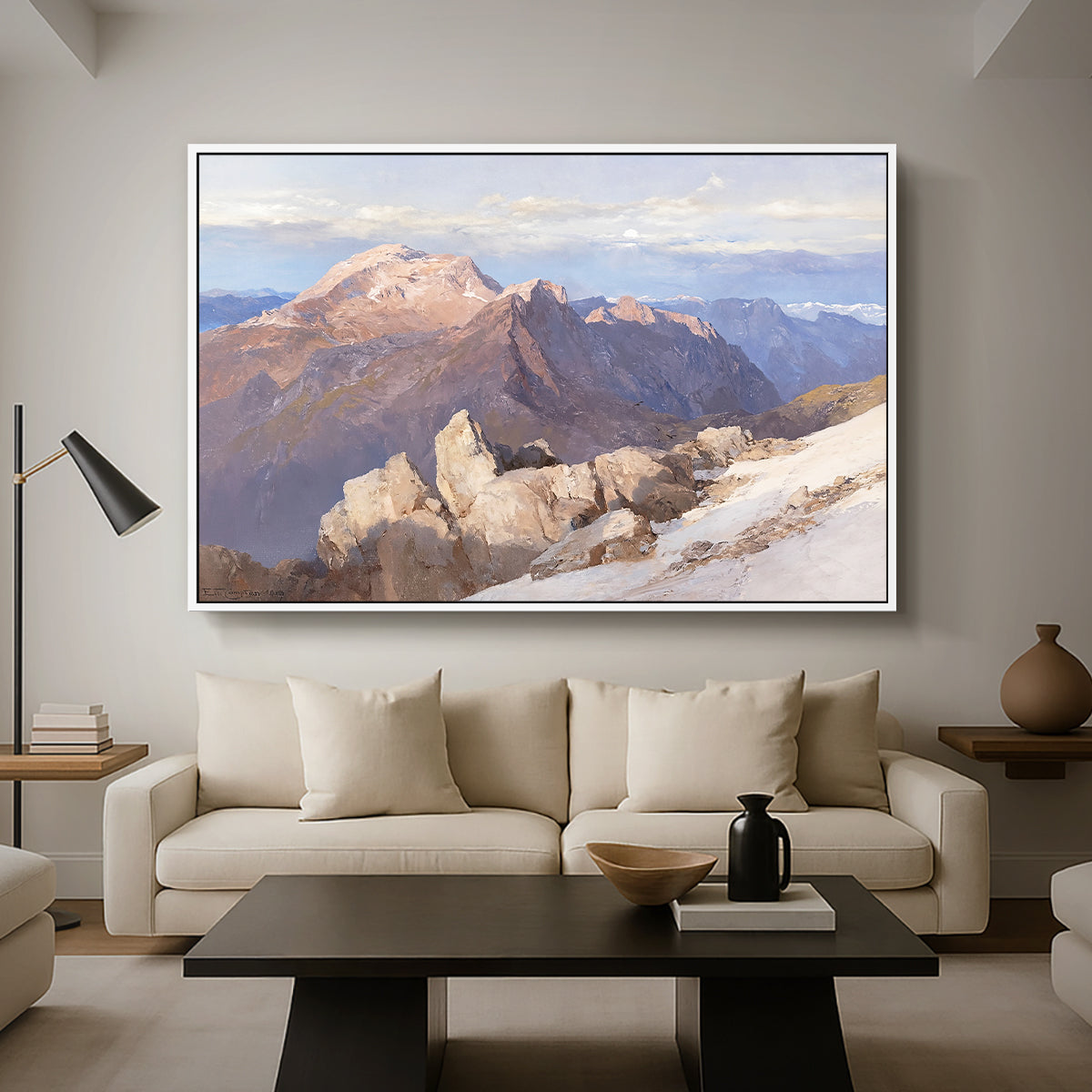 Hoher Göll from Watzmann-Hocheck, 1919 by Edward Theodore Compton as a white floater framed canvas featuring a distant mountain peak viewed from elevated ridge with sweeping landscape, displayed above a sofa in a modern living room.