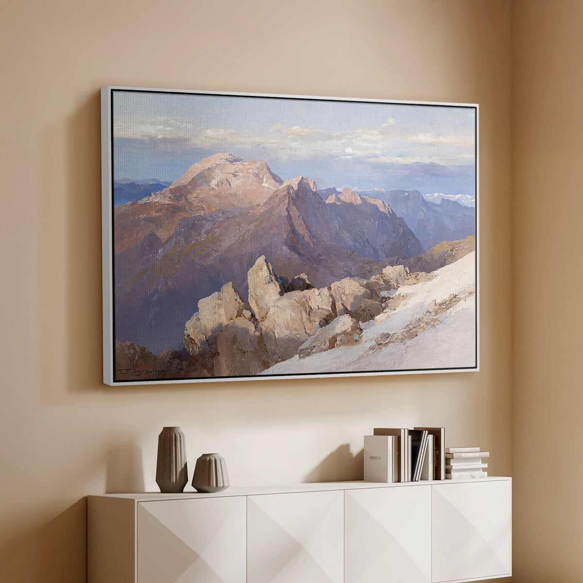 White floater framed canvas of Hoher Göll from Watzmann-Hocheck, 1919 by Edward Theodore Compton, featuring an alpine panorama showing layered peaks and valleys above a console cabinet in a minimalist entryway.