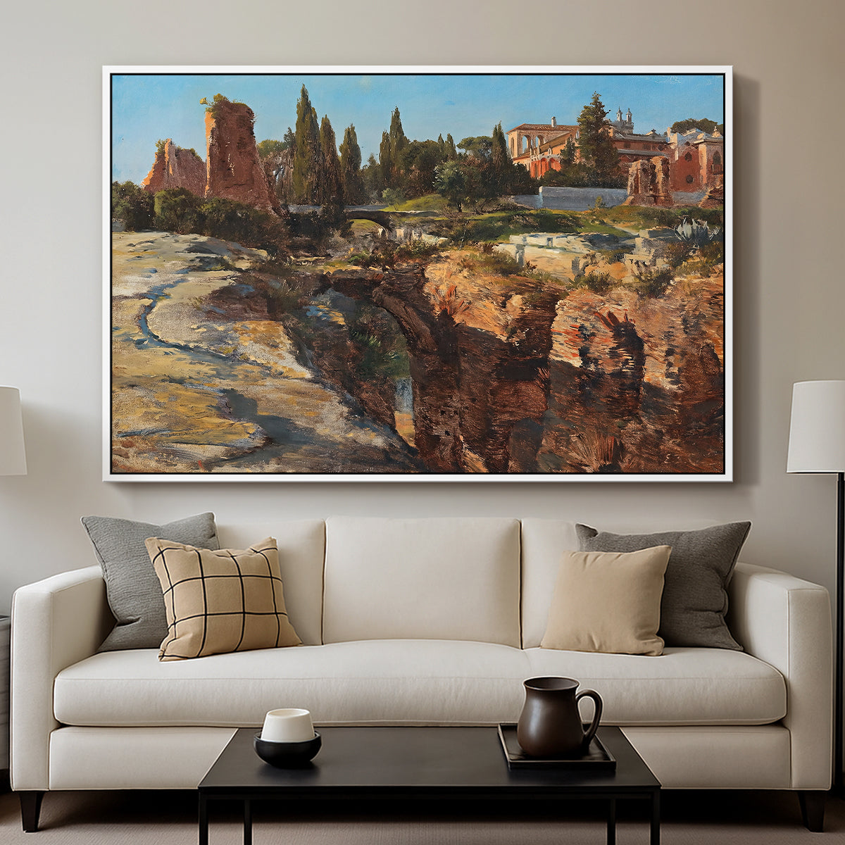 Palatine in Rome, c. 1921 by Edward Theodore Compton displayed in a white floater framed canvas above a sofa in a clean living room.