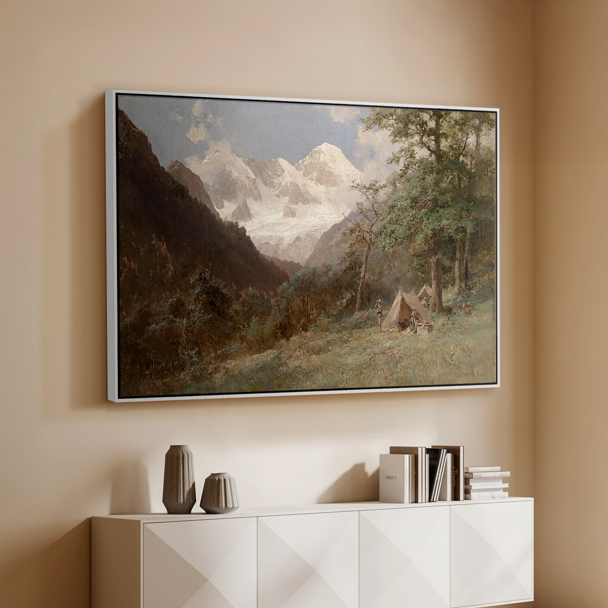 White floater framed canvas of Landscape in the Caucasus, c. 1921 by Edward Theodore Compton, featuring an expansive view of Caucasus mountains under open sky above a console cabinet in a minimalist entryway.