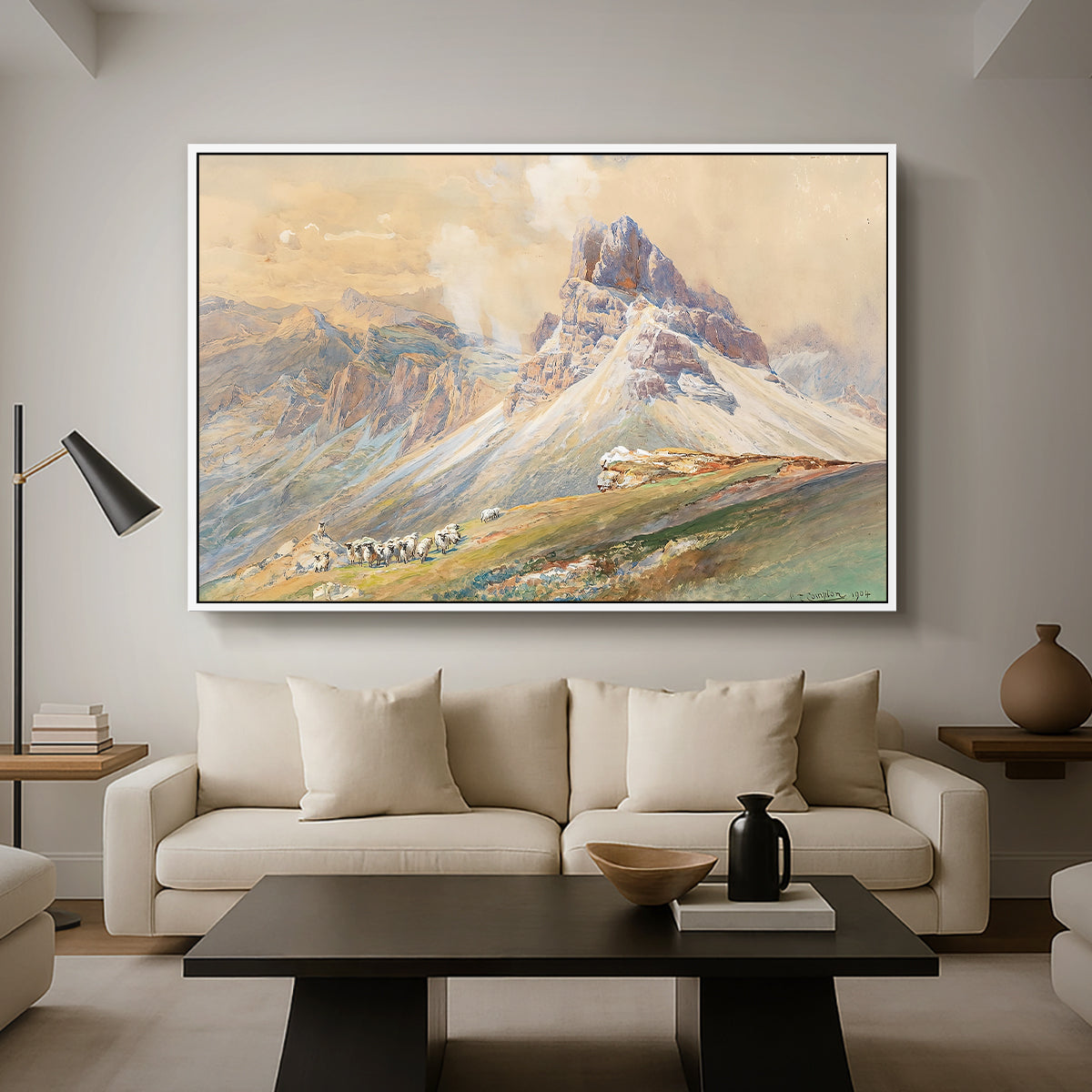 From the Dolomites, 1904 by Edward Theodore Compton as a white floater framed canvas featuring dramatic Dolomite mountain peaks rising above rugged terrain, displayed above a sofa in a modern living room.