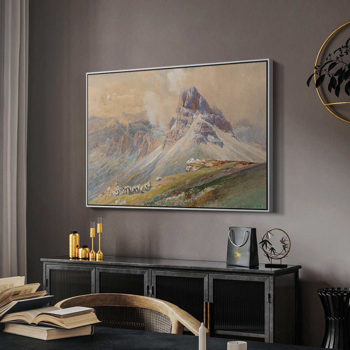 From the Dolomites, 1904 by Edward Theodore Compton in a white floater framed canvas featuring an expansive landscape featuring iconic Dolomite peaks, displayed above a desk in a dark home office interior.