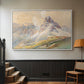 White floater framed canvas featuring a realistic mountain view with strong geological forms, displayed in a hallway near a staircase.