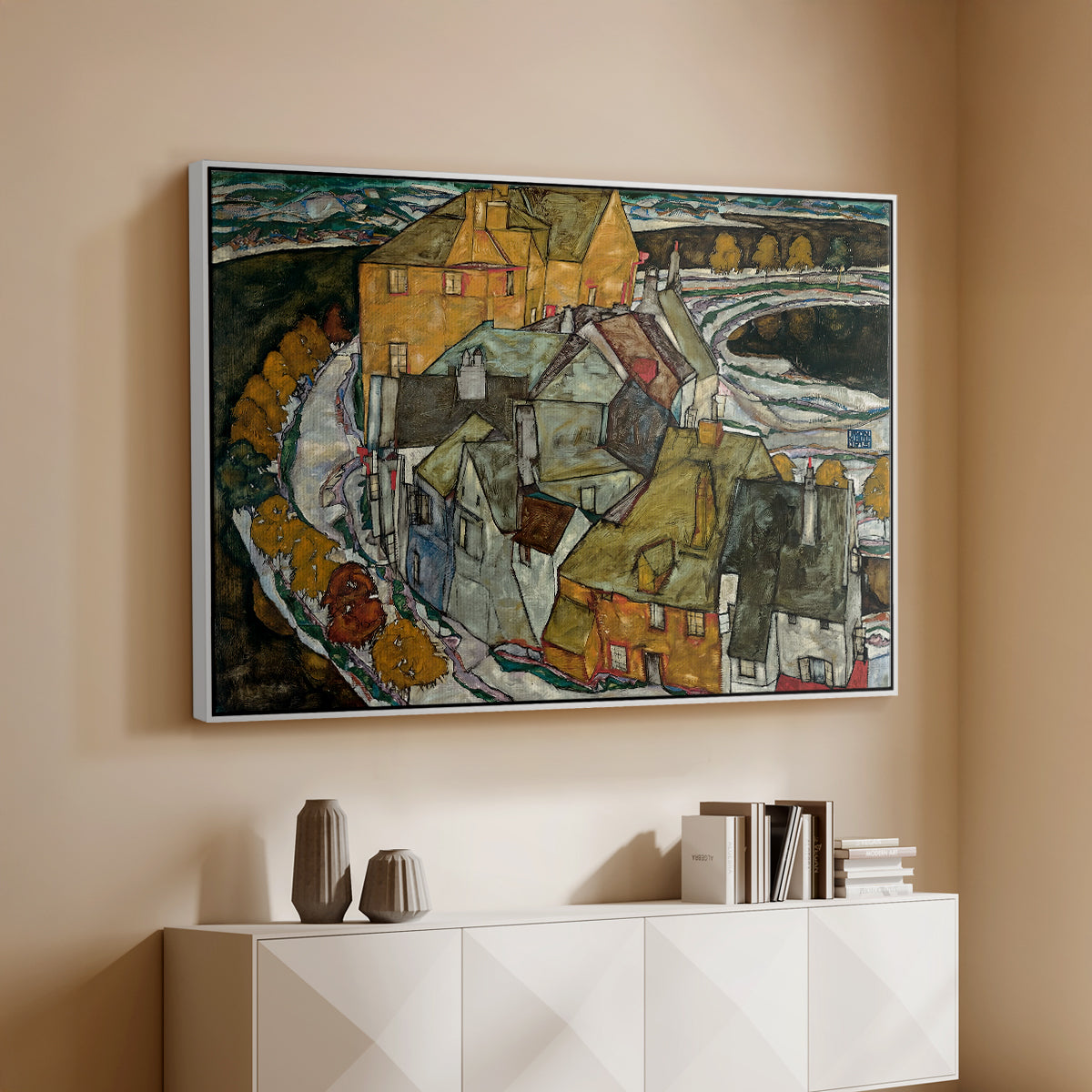 White floater framed canvas of Crescent of Houses II (Island Town), 1915 by Egon Schiele, featuring a stylized townscape with clustered buildings and bold outlines above a console cabinet in a minimalist entryway.