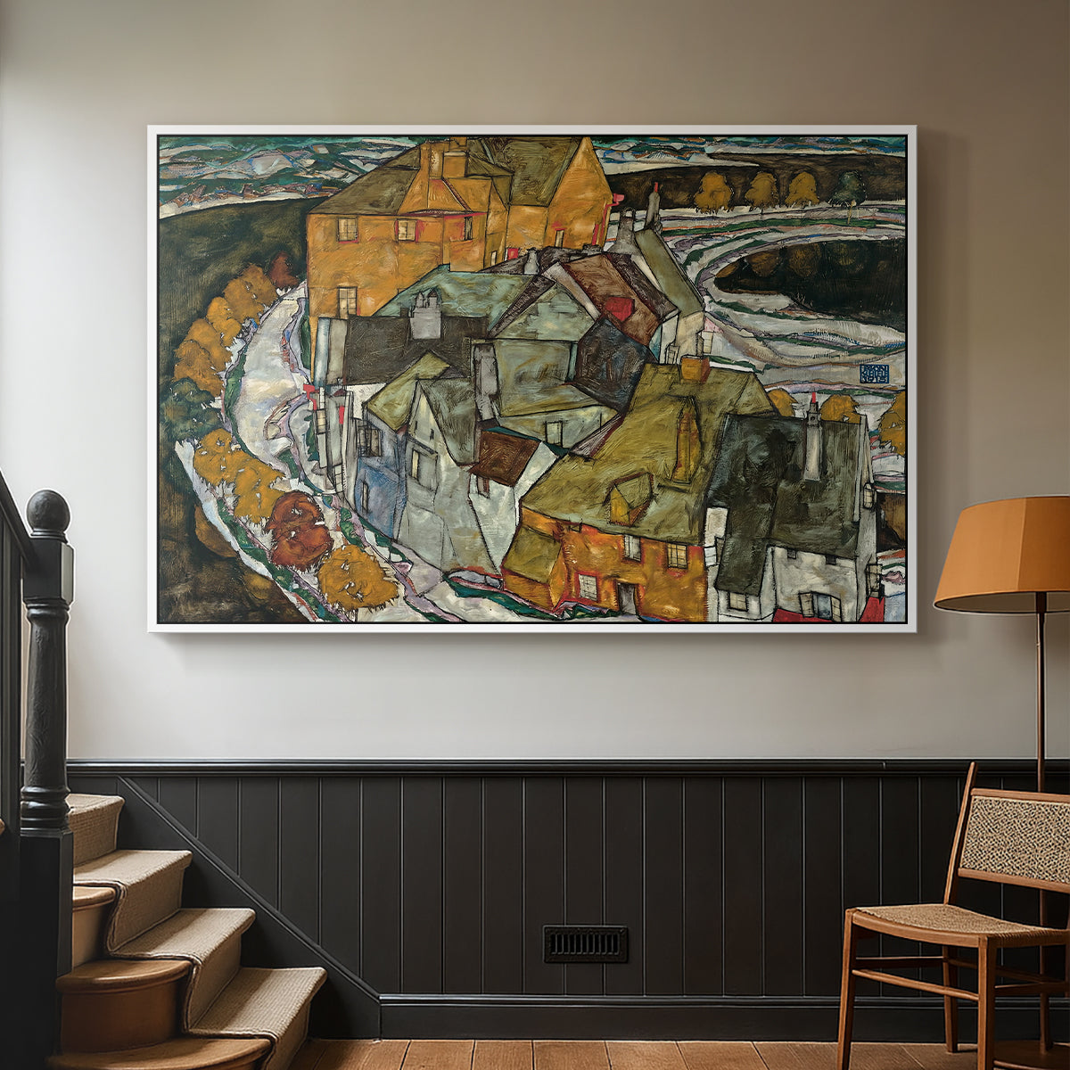 White floater framed canvas featuring an architectural scene with houses arranged in curved composition, displayed in a hallway near a staircase.