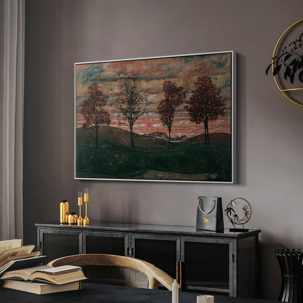 Four Trees, 1917 by Egon Schiele in a white floater framed canvas featuring a stylized nature scene with strong outlines and simple composition, displayed above a desk in a dark home office interior.