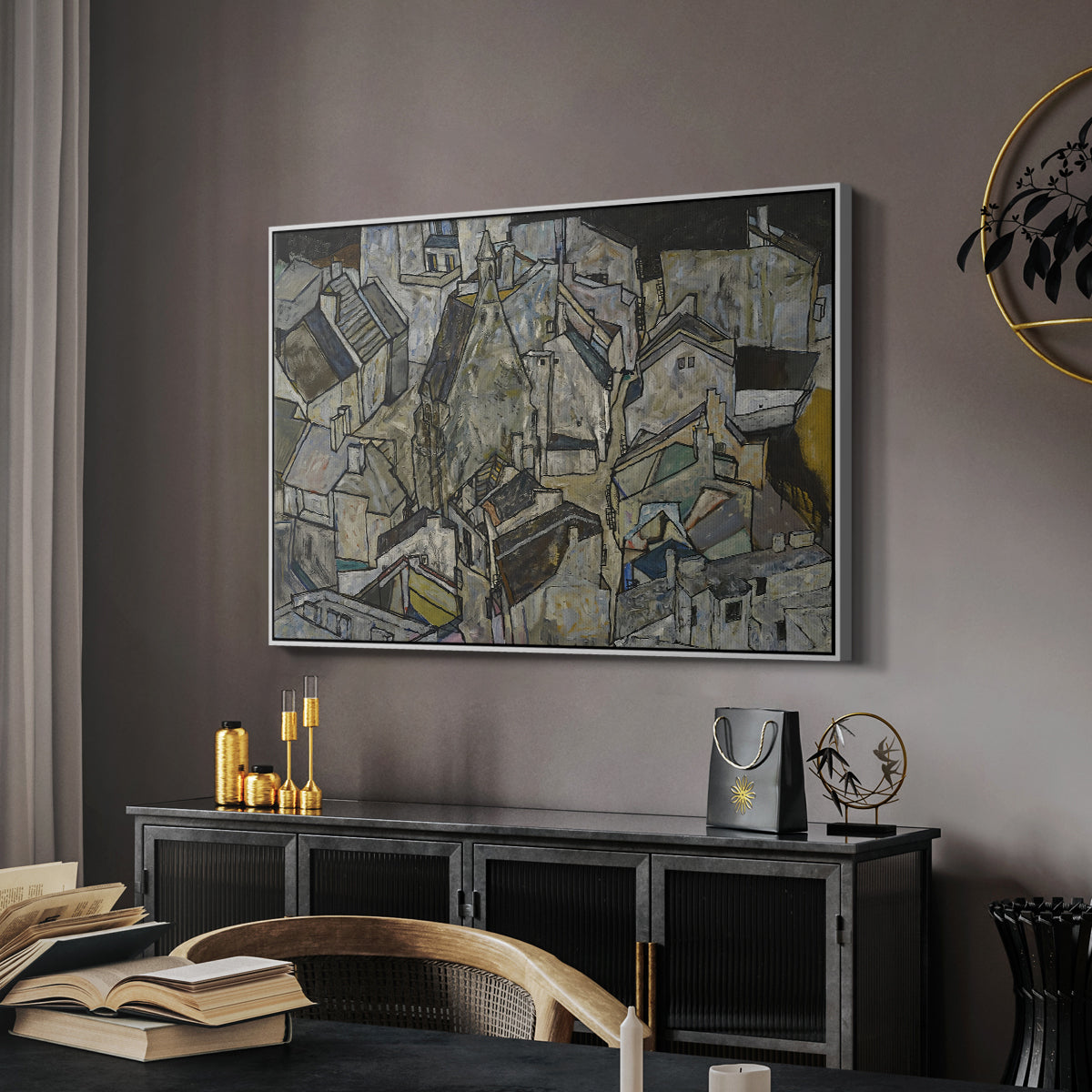 Mödling II, 1918 by Egon Schiele in a white floater framed canvas featuring an abstracted town view with angular rooftops and fragmented forms, displayed above a desk in a dark home office interior.