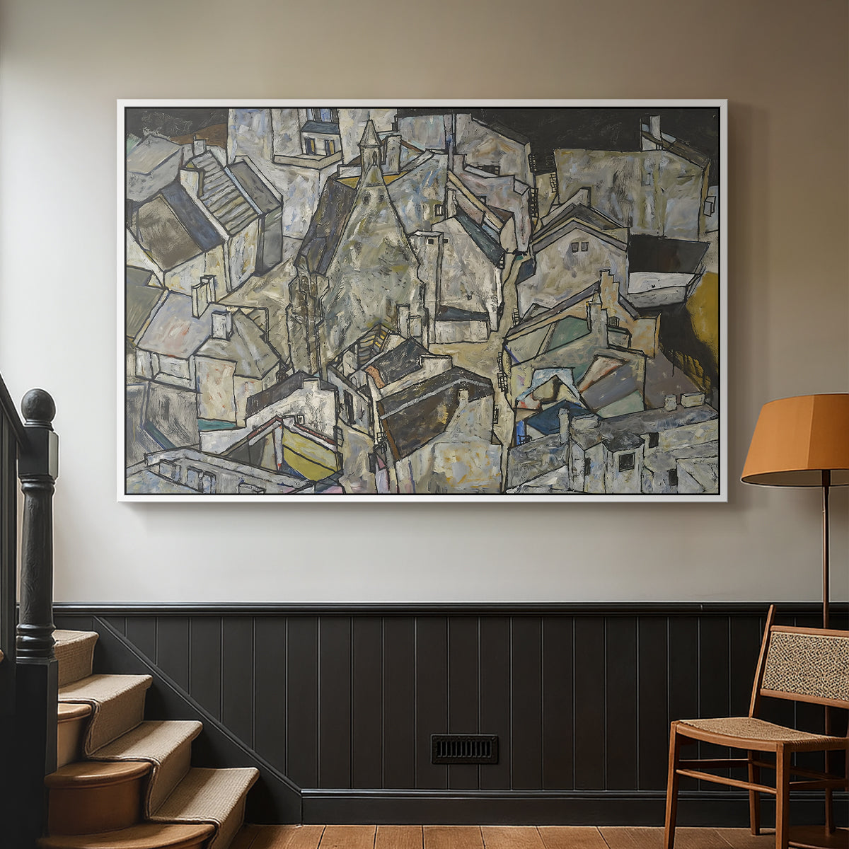White floater framed canvas featuring a stylized urban composition with geometric structures and muted tones, displayed in a hallway near a staircase.