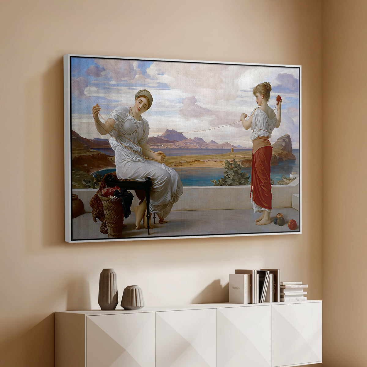 White floater framed canvas of Winding the Skein, c. 1878 by Frederic Leighton, featuring two women engaged in textile work with draped garments above a console cabinet in a minimalist entryway.