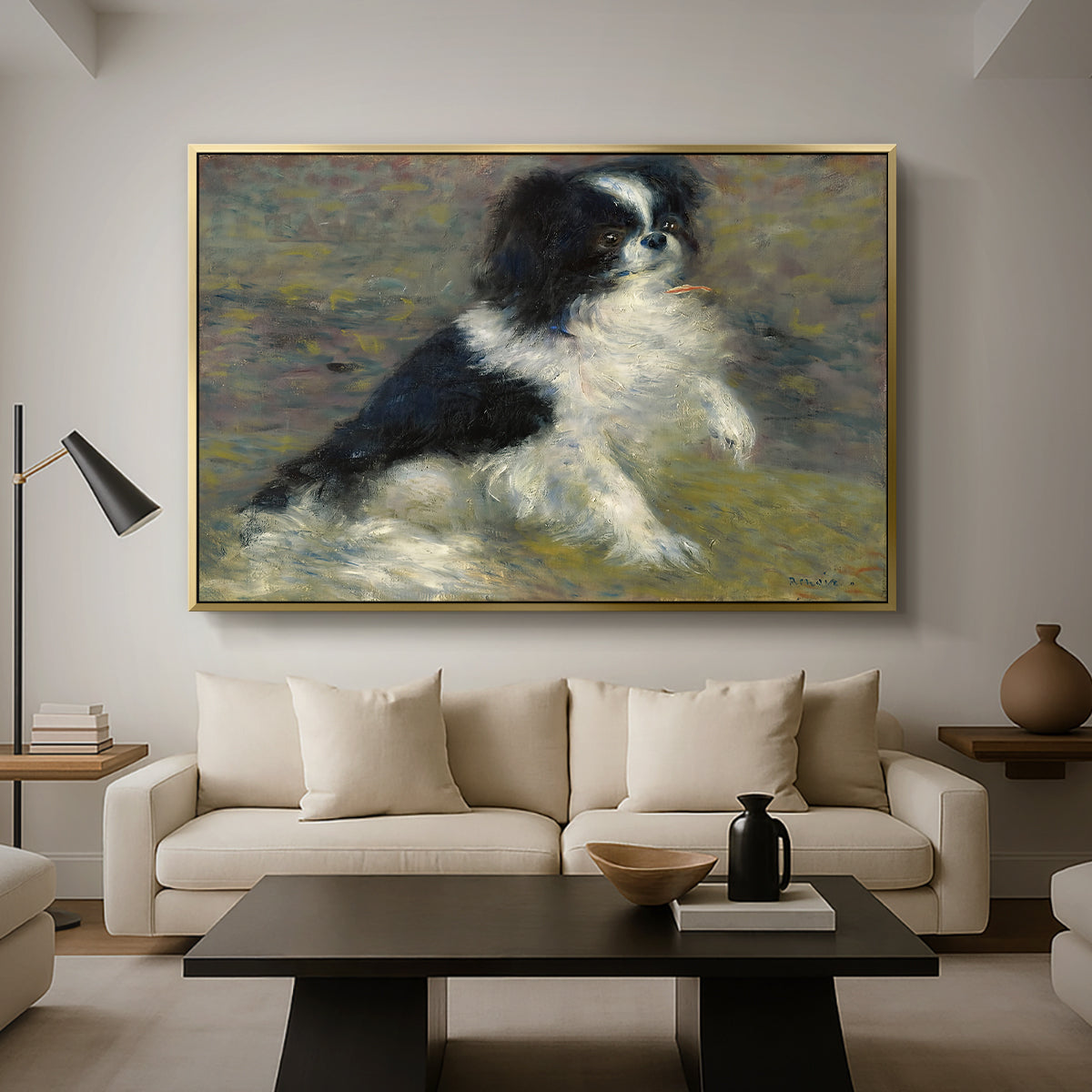 Tama, the Japanese Dog, c. 1876 by Pierre-Auguste Renoir as a gold floater framed canvas featuring a small black and white dog standing in shallow water with soft brushstrokes, displayed above a sofa in a modern living room.