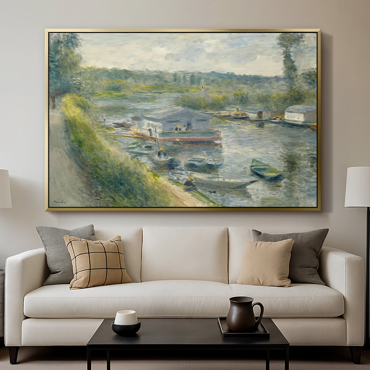 Wash-House Boat at Bas-Meudon, c. 1874 by Pierre-Auguste Renoir displayed in a gold floater framed canvas above a sofa in a clean living room.
