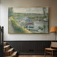 Gold floater framed canvas featuring an everyday life scene with boat and figures along river edge, displayed in a hallway near a staircase.