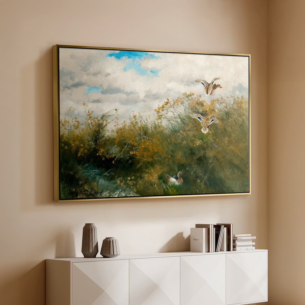 Gold floater framed canvas of Wild Ducks (Grasänder), 1890 by Bruno Liljefors, featuring a wildlife scene of ducks walking through tall grass beside water above a console cabinet in a minimalist entryway.
