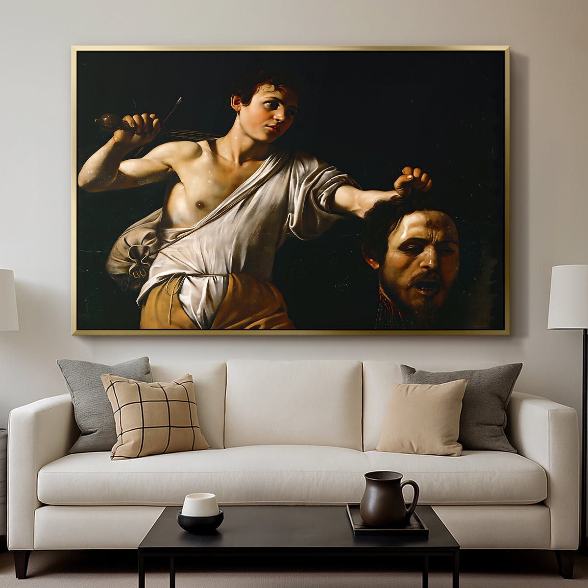 David with the Head of Goliath (Vienna Version), c. 1607 by Caravaggio displayed in a gold floater framed canvas above a sofa in a clean living room.