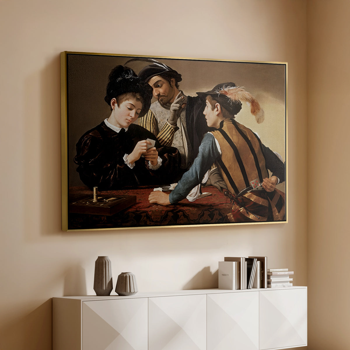 Gold floater framed canvas of The Cardsharps, c. 1594 by Caravaggio, featuring a genre scene of card game with deception and hidden accomplice above a console cabinet in a minimalist entryway.