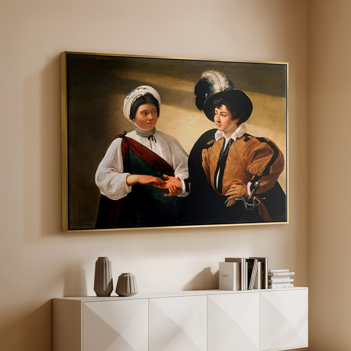Gold floater framed canvas of The Fortune Teller (Louvre Version), c. 1595 by Caravaggio, featuring a fortune teller examining hand of man as she slyly removes his ring above a console cabinet in a minimalist entryway.