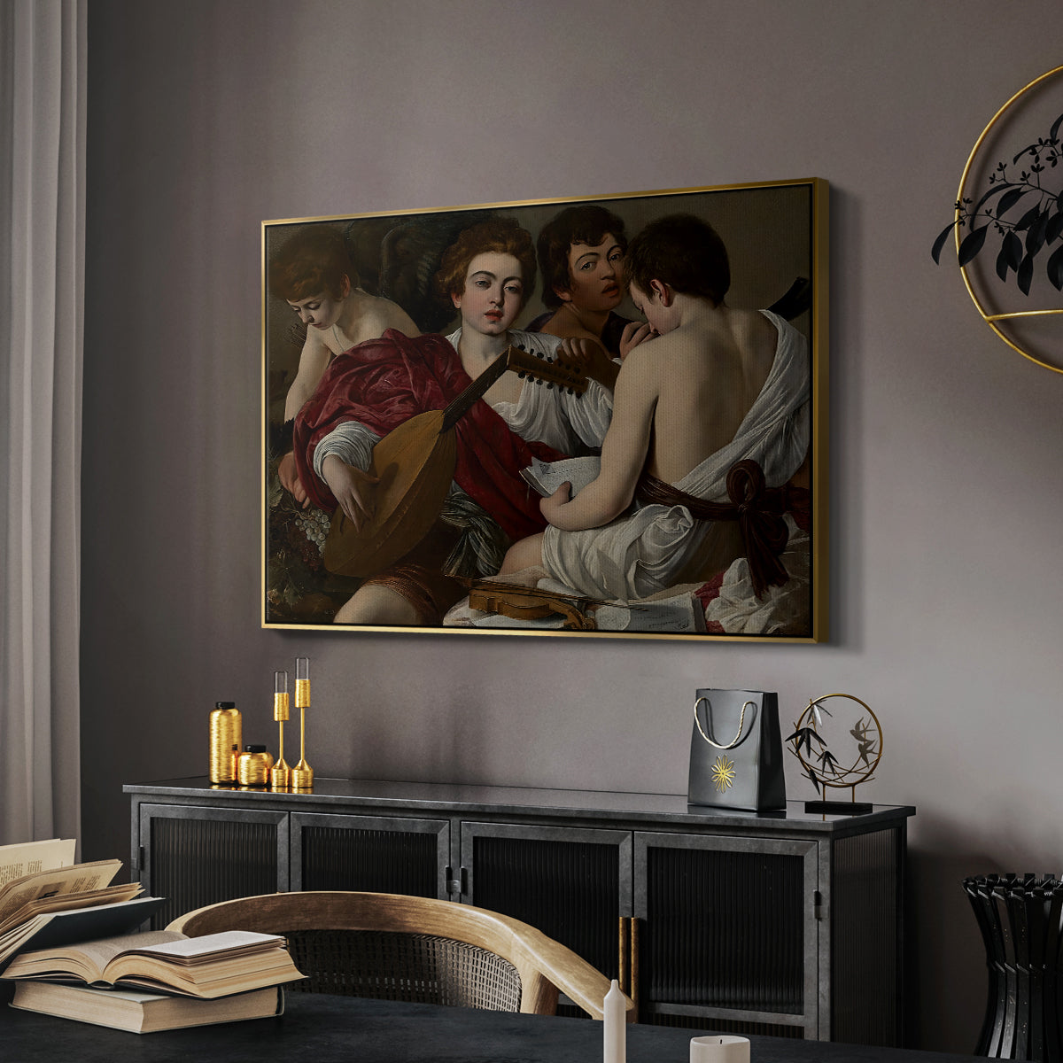 The Musicians, c. 1595 by Caravaggio in a gold floater framed canvas featuring an intimate scene of youths making music with sheet music and instruments, displayed above a desk in a dark home office interior.