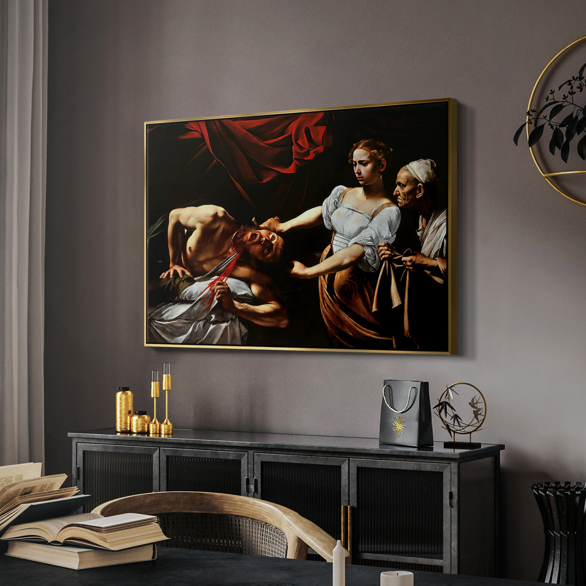 Judith Beheading Holofernes, c. 1599 by Caravaggio in a gold floater framed canvas featuring an intense moment of Judith slaying Holofernes with sword, displayed above a desk in a dark home office interior.