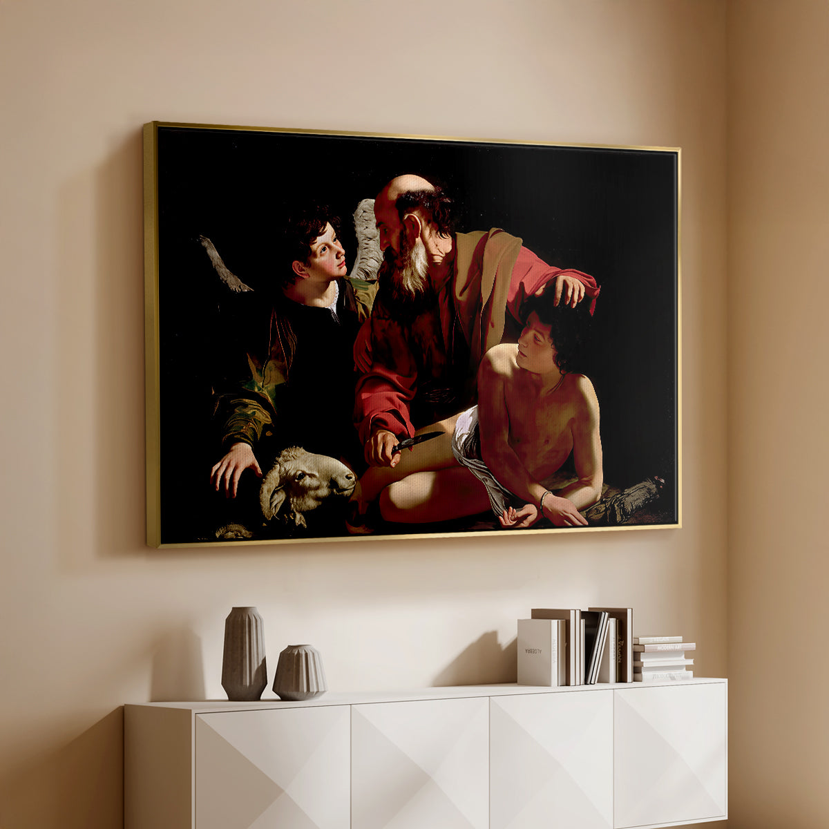 Gold floater framed canvas of The Sacrifice of Isaac (Uffizi Version), c. 1603 by Caravaggio, featuring a biblical scene of father about to sacrifice son as angel restrains him above a console cabinet in a minimalist entryway.