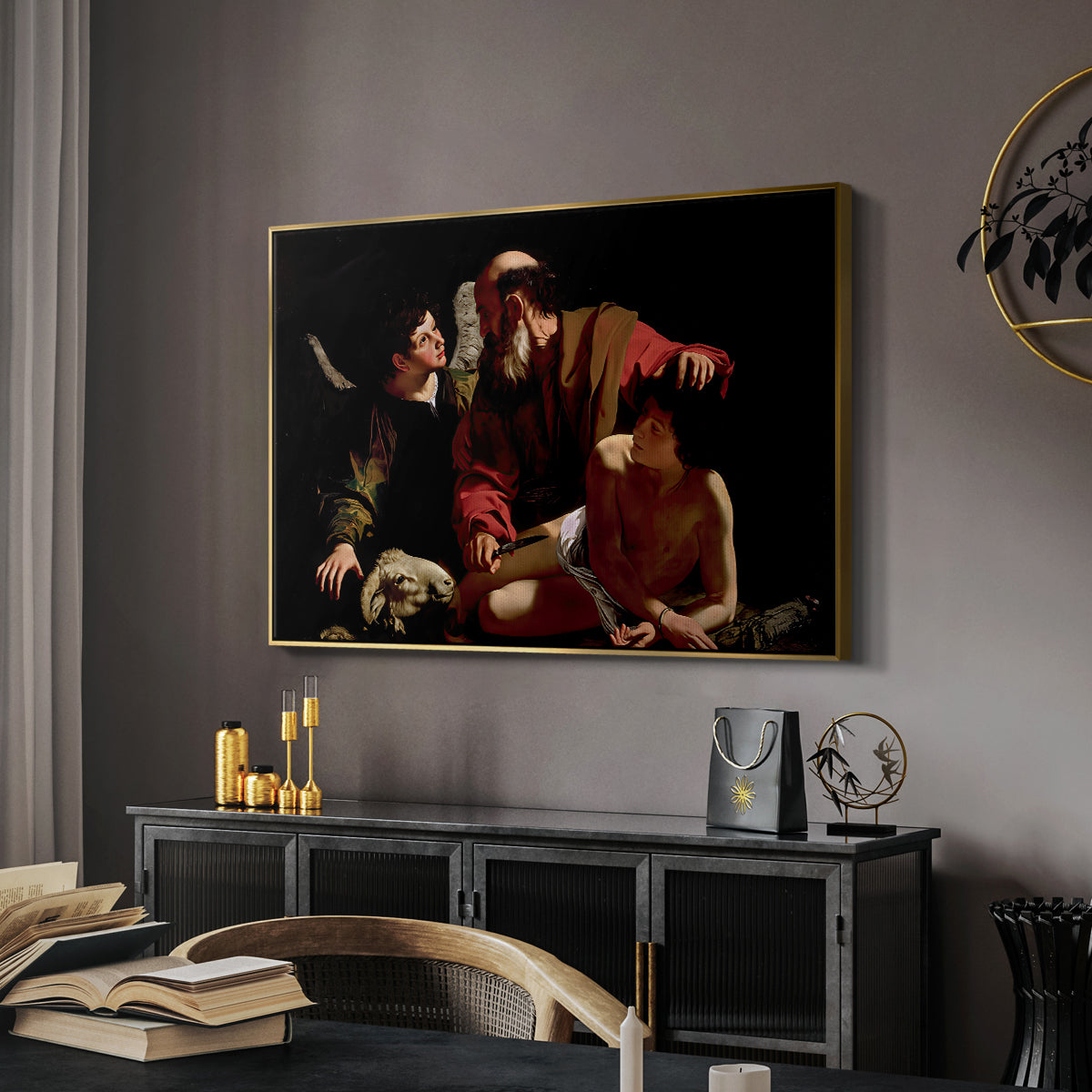 The Sacrifice of Isaac (Uffizi Version), c. 1603 by Caravaggio in a gold floater framed canvas featuring a dramatic moment of divine intervention during sacrifice of Isaac, displayed above a desk in a dark home office interior.