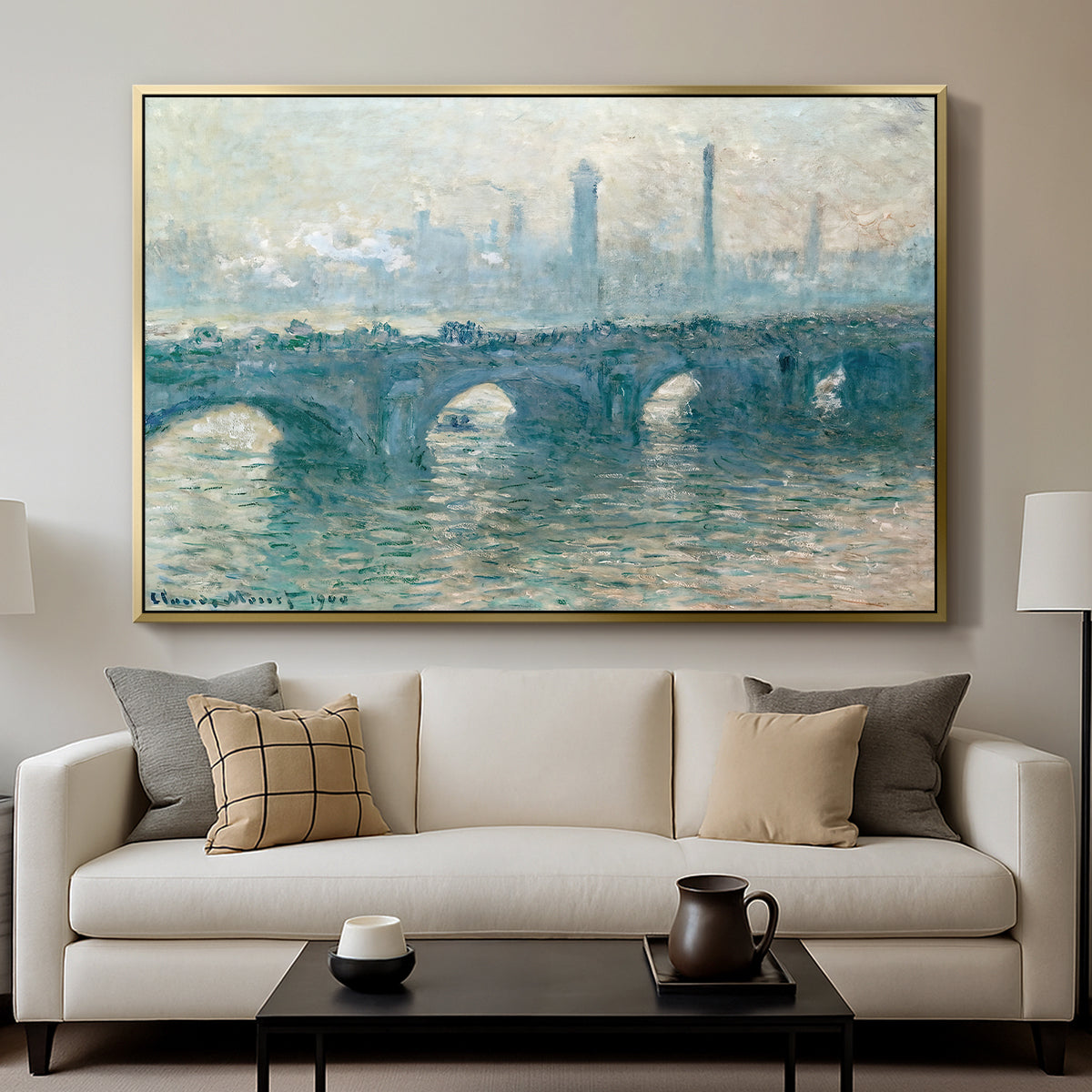 Waterloo Bridge, Gray Weather, 1900 by Claude Monet displayed in a gold floater framed canvas above a sofa in a clean living room.