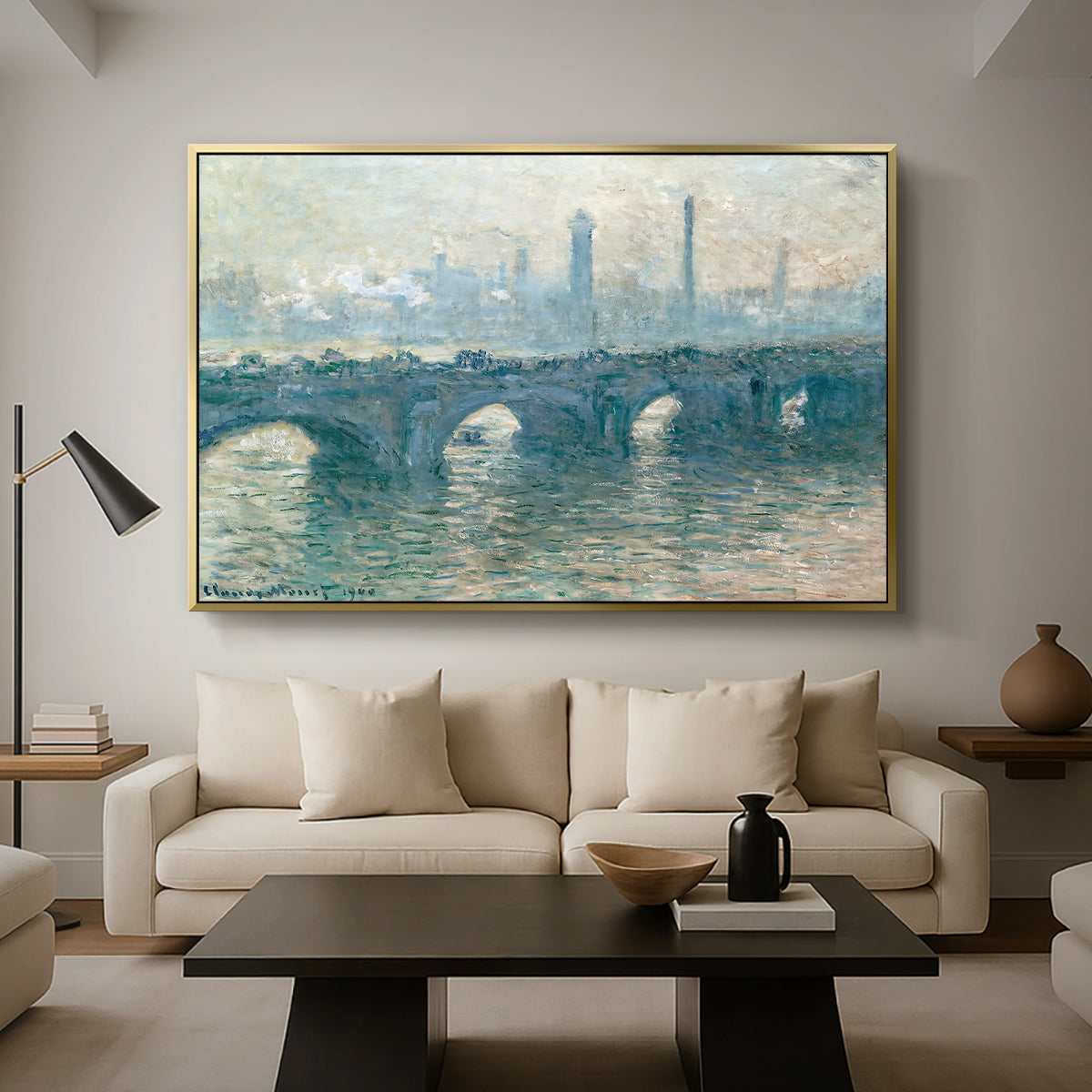 Waterloo Bridge, Gray Weather, 1900 by Claude Monet as a gold floater framed canvas featuring a hazy view of Waterloo Bridge over river in gray atmospheric light, displayed above a sofa in a modern living room.