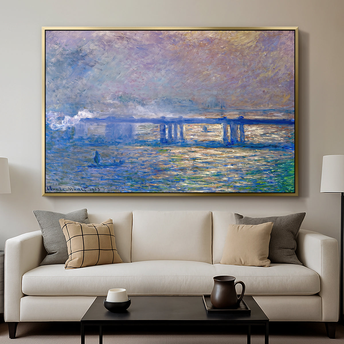 Charing Cross Bridge, 1903 by Claude Monet displayed in a gold floater framed canvas above a sofa in a clean living room.