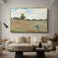 The Poppy Field near Argenteuil, 1873 by Claude Monet as a gold floater framed canvas featuring a field of red poppies with figures walking across rolling landscape, displayed above a sofa in a modern living room.