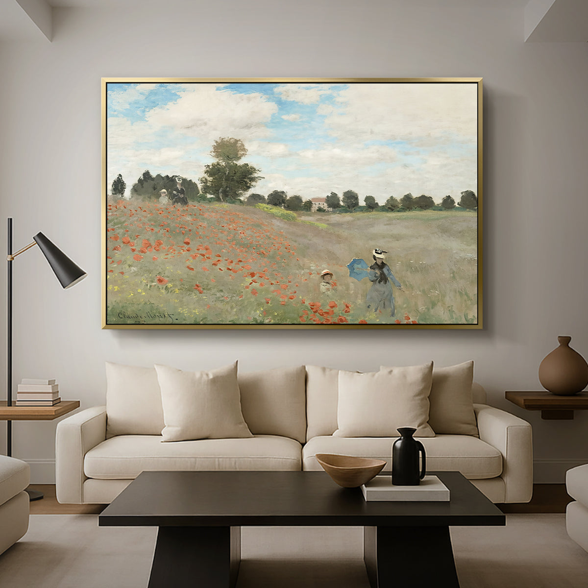 The Poppy Field near Argenteuil, 1873 by Claude Monet as a gold floater framed canvas featuring a field of red poppies with figures walking across rolling landscape, displayed above a sofa in a modern living room.