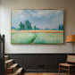 Gold floater framed canvas featuring a serene rural scene with textured wheat under natural light, displayed in a hallway near a staircase.