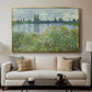 Banks of the Seine, Vétheuil, 1880 by Claude Monet displayed in a gold floater framed canvas above a sofa in a clean living room.