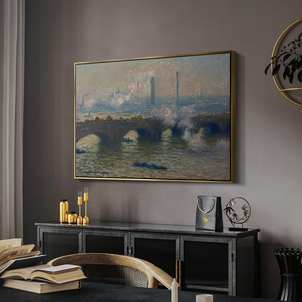 Waterloo Bridge, Gray Day, 1903 by Claude Monet in a gold floater framed canvas featuring a river and bridge scene with diffused light and urban backdrop, displayed above a desk in a dark home office interior.