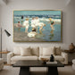 A Holiday, c. 1915 by Edward Henry Potthast as a gold floater framed canvas featuring people relaxing and wading in shallow ocean water along a sunny beach, displayed above a sofa in a modern living room.