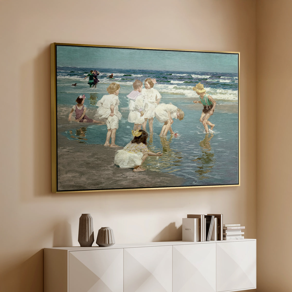 Gold floater framed canvas of A Holiday, c. 1915 by Edward Henry Potthast, featuring a beach scene with figures bathing and standing in waves under bright sky above a console cabinet in a minimalist entryway.