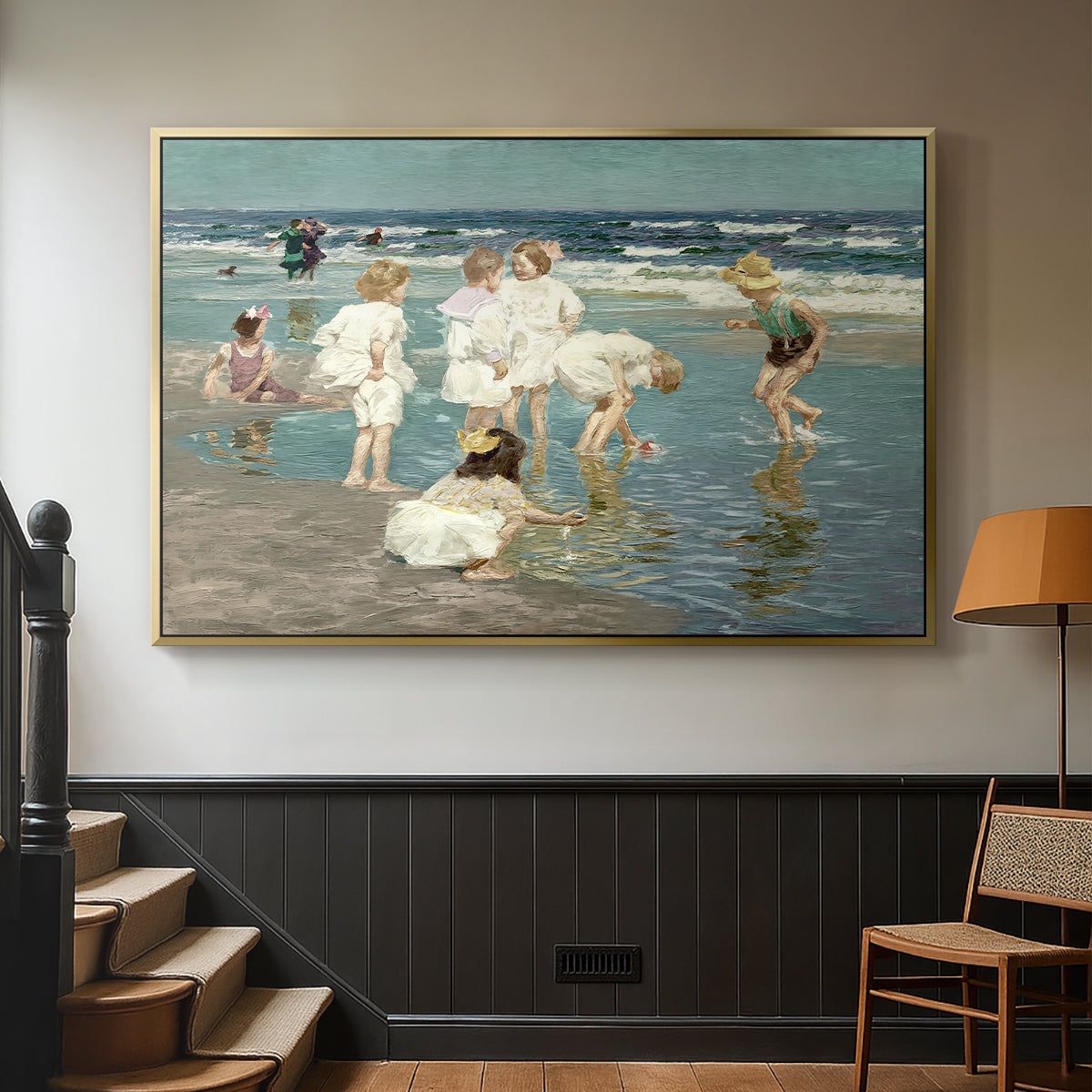Gold floater framed canvas featuring a lively shoreline scene with people gathered in surf, displayed in a hallway near a staircase.