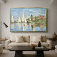 Regatta at Argenteuil, 1872 by Claude Monet as a gold floater framed canvas featuring colorful sailboats racing across river under bright sky, displayed above a sofa in a modern living room.