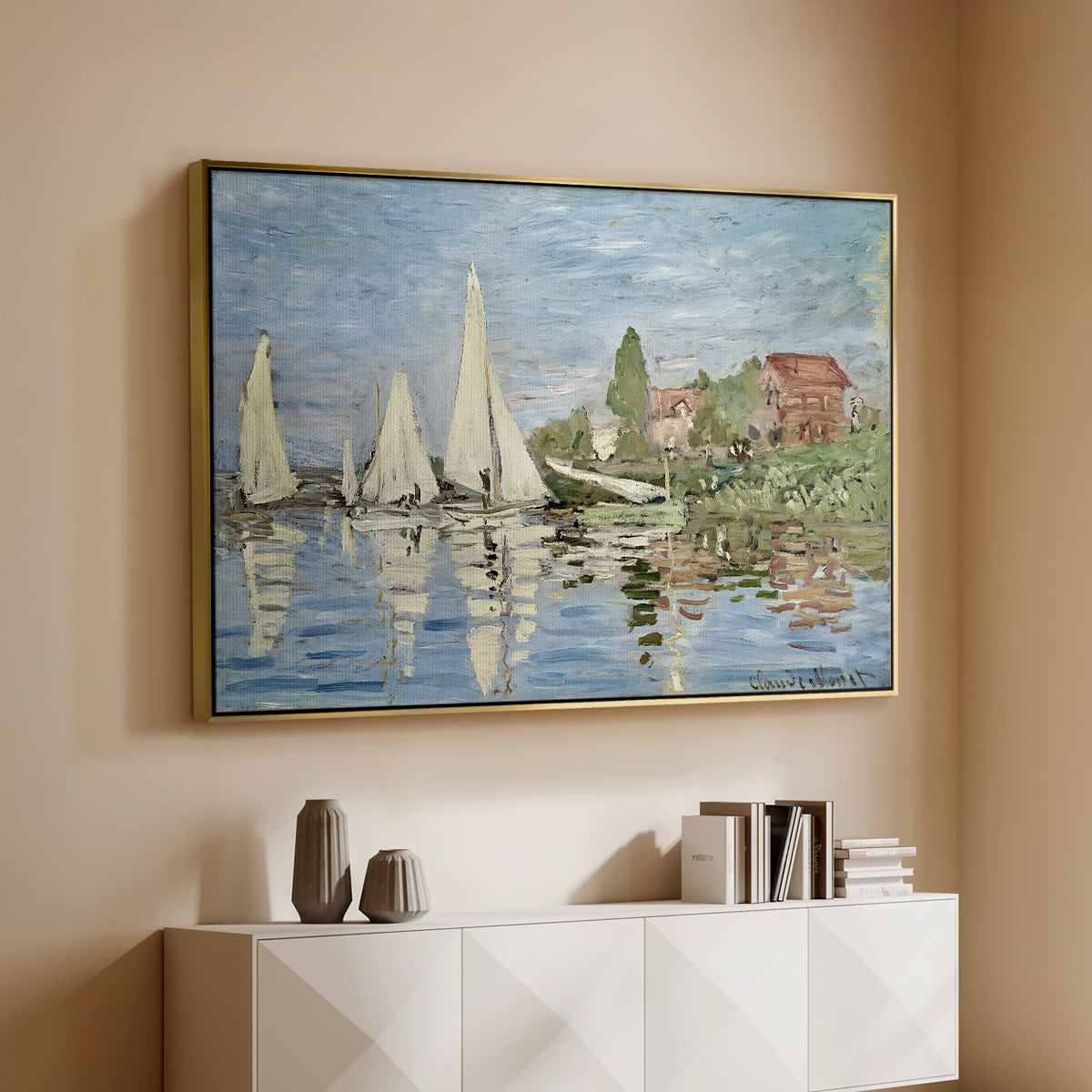 Gold floater framed canvas of Regatta at Argenteuil, 1872 by Claude Monet, featuring a lively regatta scene with multiple boats and fluttering sails above a console cabinet in a minimalist entryway.